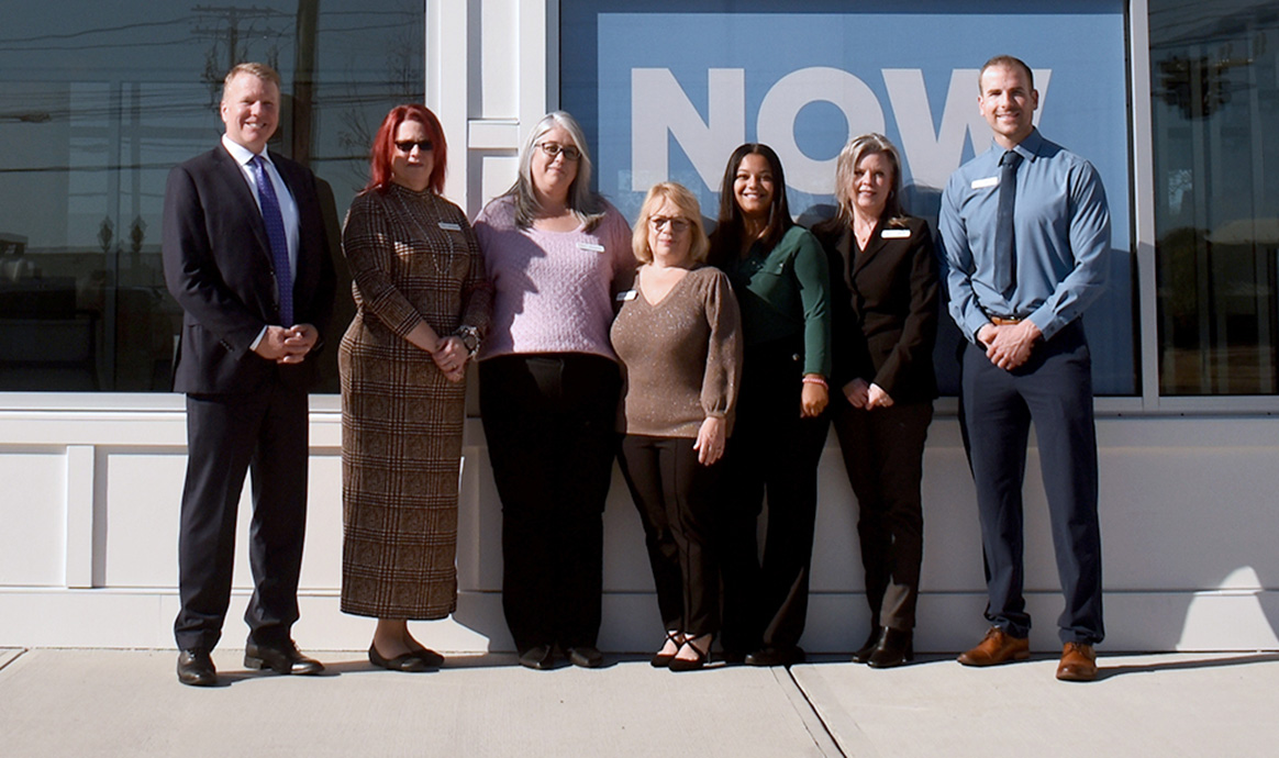 MVCU President & CEO John J. Howard smiles with Plymouth branch staff. From left: Branch Manager Joanne Bennett, Teller Operations Supervisor Christina Flint, Lead Teller Wendy Ricardo, Universal Banker Darrylee Gray, Financial Services Representative The